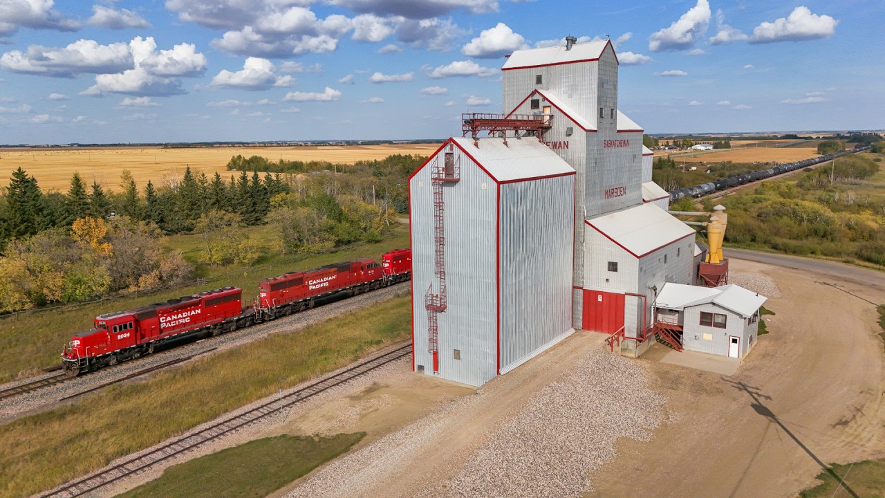 The Wilkie to Lloydminster local makes it way past the elevator at Baldwinton with CP 5034, CP 6258 and CP 3061 and 72 cars.