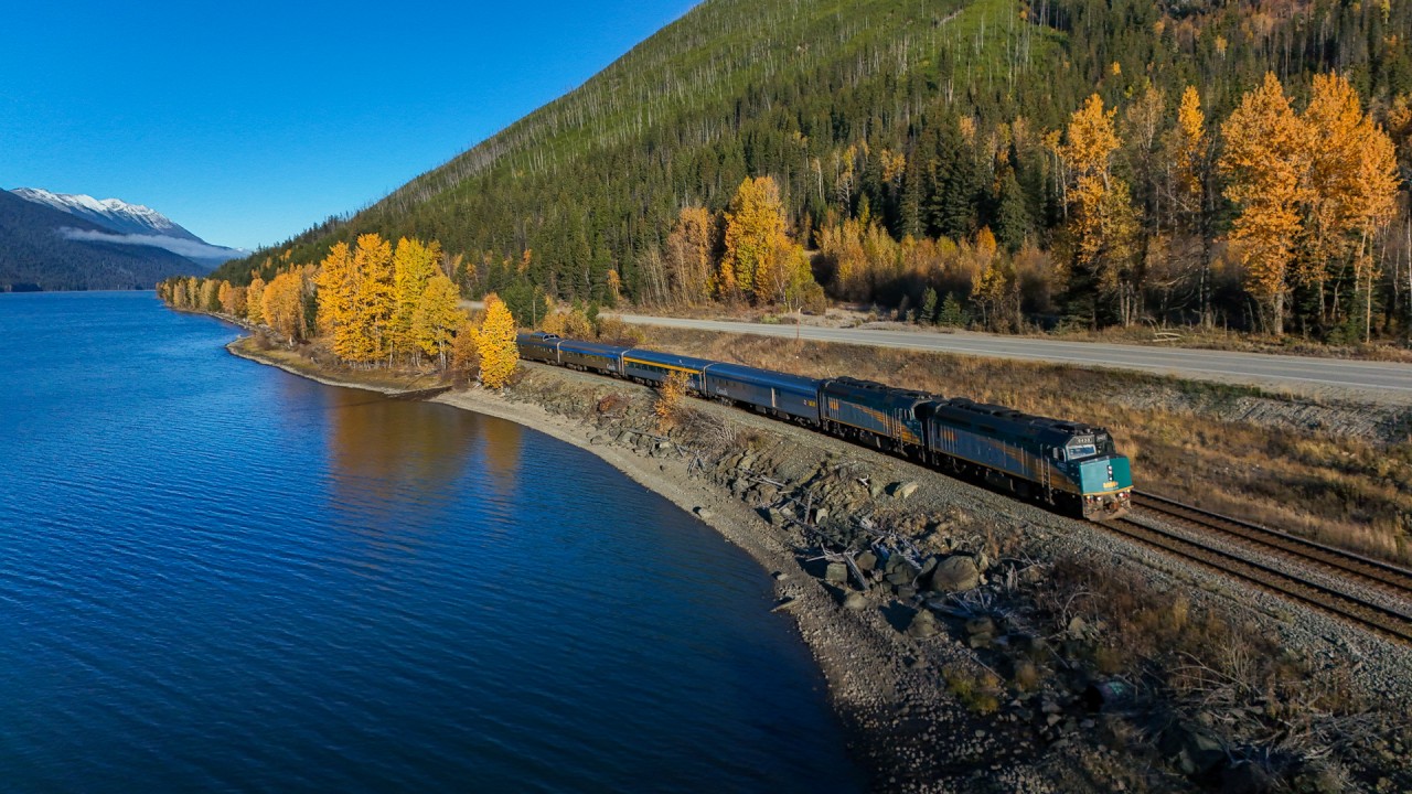 The fall colours are in full swing as the eastbound Canadian runs along the shore of Moose Lake.
