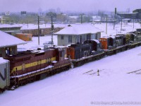 An extra freight bound for Montreal passes through Danforth with an eclectic mix of power on the head end, in the form of a GP9, RS18, RS3, and DMIR SD9.  During the winters beginning 1963-1964 through the winter of 1973-1974, DM&IR SD9s and SD18s were often leased by CN, as well as CP and other lines, to fill out power shortages. The winter of 1965/66 saw CN leasing 20 units.

<br><br><i>John Freyseng Photo, Jacob Patterson Collection Slide.</i>