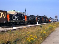 Eastbound around York street at the west end of Union Station, five switchers head up what is likely a transfer to Toronto Yard through downtown Toronto.

<br><br><i>Scan and editing by Jacob Patterson.</i>