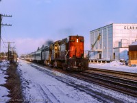 Passing the Clarkson cold storage building, CN passenger extra 3113 west approaches the crossing at Clarkson Road.  The cold storage building and the rest of the property was cleared between 2020 - 2022 for condos.

<br><br><i>John Freyseng Photo, Jacob Patterson Collection Slide.</i>