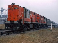 A pair of CN Tempo RS18ms idle away in the rain at Elmira while passengers of the seven car train have alighted to sample the sweet tastes of the Elmira Maple Syrup Festival.

<br><br><a href=https://www.railpictures.ca/?attachment_id=55371>The other side</a>

<br><br><i>Scan and editing by Jacob Patterson.</i>