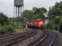 Swinging off the high trestle at Parry Sound, a northbound freight approaches the station and small yard.

<br><br><i>Scan and editing by Jacob Patterson.</i>