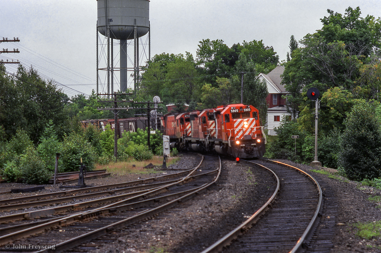 Swinging off the high trestle at Parry Sound, a northbound freight approaches the station and small yard.

Scan and editing by Jacob Patterson.