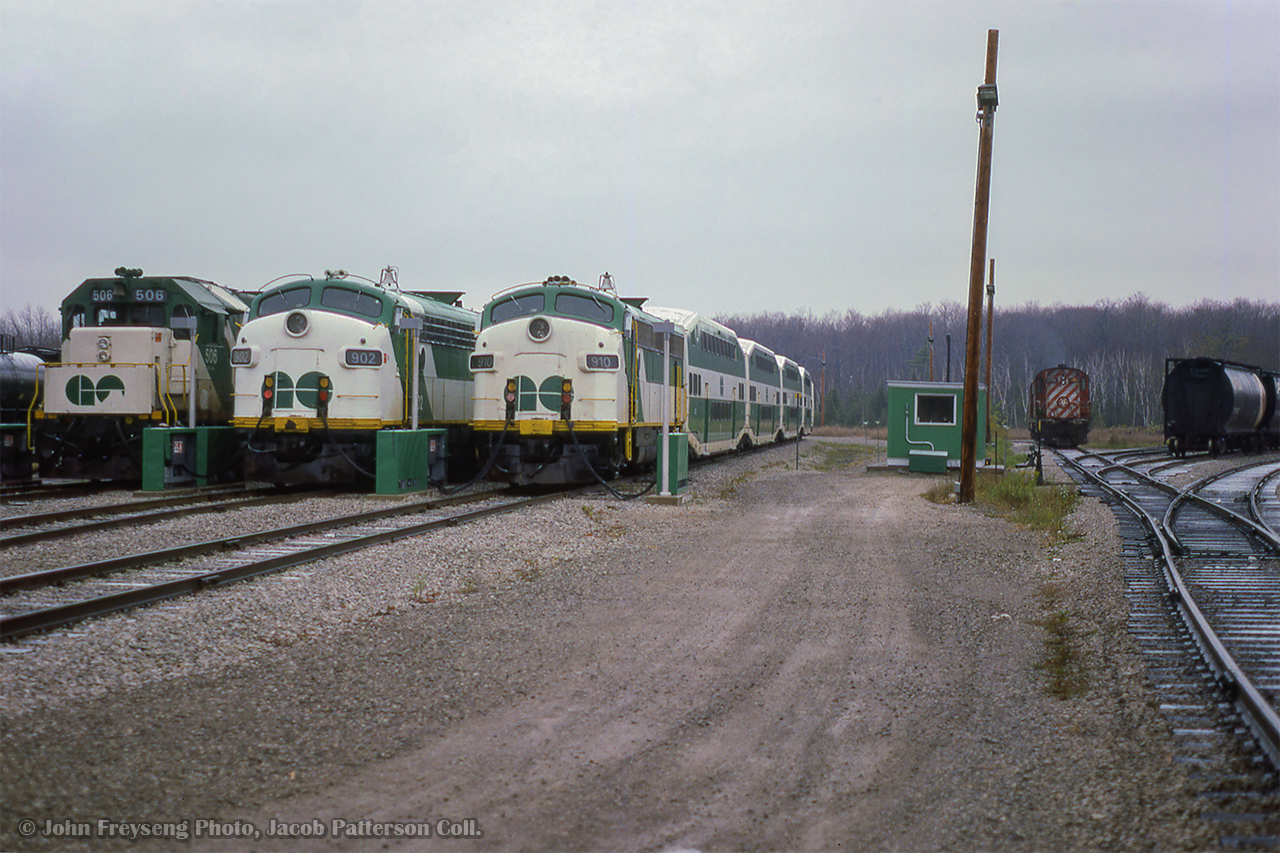 Three GO Transit consists tied down at Guelph Junction await their next runs to Toronto.  Off to the right, a pair of MLW RS18 units will be the power for the Guelph Junction road switcher.

Making up their train
Departing for Waterdown North.

John Freyseng Photo, Jacob Patterson Collection Slide.