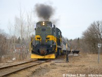 With the RERA crew in a celebratory mood, and extra flags flapping, smoke was coaxed out of 3612's 251 block for the photographers waiting for the final departure out of Goodwood on March 29 2026.<br><br> It took three months, and it was only supposed to be a single day of movements back on <a href=http://www.railpictures.ca/?attachment_id=58053 target=_blank>December 21 2025</a>, but the Railroad Equipment Restoration Association pulled it off. Despite numerous attempts over the winter, extreme cold, snow, and motive power that can be best described as "temperamental", warmer weather coupled with mechanical repairs to 3612 and the movements started actually going off without a hitch. Goodwood, a hamlet that once had a Station and passenger trains, along with a grain elevator and frequent service, was mostly silent for the last few decades. Between December and March, Goodwood became a beehive of activity: Mechanical repairs were conducted on equipment, locomotives were watered, repaired and tested, crews reported for duty and when everything worked, trains operated along the Uxbridge sub between "the dip" (A location 4 miles south of Uxbridge) and Lincolnville all based out of Goodwood. The best part? It was all done with locomotives with prime movers designed in 1944 and 1951, MLW/ALCo's, which as noted in December, are a dying breed in Ontario.<br><br>All of it came to an end on March 29 2026: Pictured the last cut of cars is now ready to go, mechanical modifications to the cars are completed, and the last order of business is to load the train with *everything left* that wasn't already tied down into the coaches. You see, the RERA purchased *everything* that the former YDHR owned, including all sundries: this included old souvenirs, TV's, mechanical equipment, uniforms, stuff in storage, historical artefacts, everything. The RERA was tasked, contractually, with removal of it all and it took a team of about 10-15 people to hand bomb what remained all into these coaches and send it to Saskachewan and North Bay. After the picture you see above the train would stop on the crossing and the last of it would be loaded from waiting trucks and vehicles. Then they'd reverse back to Goodwood to make one final run out of town, blasting the horn, again, to a gaggle of waiting cameras and a few locals observing the end of their tenure on the Uxbridge subdivision.<br><br>What does the future have in store for this line? At the moment, nobody knows for sure, but it would appear GO transit isn't exactly done with the railway and neither is the town. The town is working on a "railway district improvement plan" and their plans show trains calling at the Uxbridge station but with much improved lands surrounding what  I would call a GO station platform. The town and Metrolinx are also re-negotiating the lease in 2026. Could GO service happen? Is a 6 car train that far off the mark when it's only a 10 mile run and about 30 minutes from Uxbridge to Linconville at 30 MPH, then they can blast off at the Uxbridge's 50 MPH after stopping at Old Elm. Until the tracks are ripped out, never say never. A train or two to Uxbridge would also help the town re-develop the lands and reach the Province's goals of urban intensification, by right, near transit stations. We'll just have to see what happens from here. In the meantime, the 244's and 251's are silent in Uxbridge and the York Durham's legacy is now gone for good and on to better things.<br><br>Over the next few days and weeks, all this equipment would move over Metrolinx and CN to Mac Yard, and then to North Bay and Kronau, Sackachewan. For updates on the equipment and their plans, visit the RERA Canada website at <a href=http://www.reracanada.ca> www.reracanada.ca </a> where announcements are yet to be made as I type this. I couldn't be happier to see the equipment at least preserved, it took a ton of money and effort to pull this off and folks, please give the RERA a good look. They deserve it.