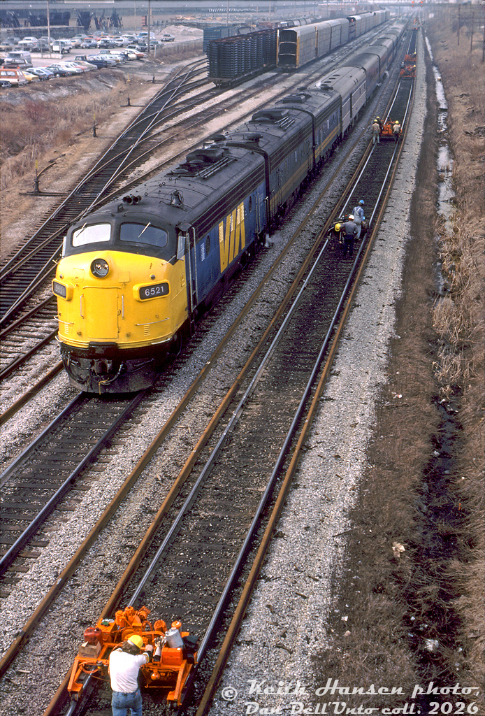 VIA FP9 6521 leads two 6600-series F9B units on an eastbound "Corridor Canadian" consist, passing CN workers doing some track upgrading on the Kingston Sub around Mile 301, as viewed from Park Road South overpass. The east end of CN's Oshawa Yard is visible, serving GM's large Oshawa assembly plant in the upper left background.

If you look very closely, you can see the domes of the Skyline and Park cars. In the early-mid 1980's, The Canadian's consist between Toronto-Montreal was run mixed with corridor trains (e.g eastbound #2 combined with #44/54) in order to, according to Eric Gagnon's post on the subject, cover the Toronto-Montreal stretch (as Sudbury-Montreal had been cancelled) and service the passenger equipment at The Glen yard in Montreal.

Keith Hansen photo, Dan Dell'Unto collection slide.