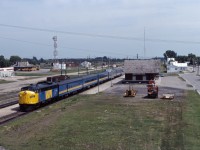 Reviving a name used for the Super Continental’s “running mate” from 24 May 1964 until 6 January 1970, VIA named its Winnipeg-Edmonton-(3 days per week) Prince Rupert train the Panorama when it was introduced on 3 June 1984. The train and name only lasted for about a year, after which the Super was reinstated between Winnipeg and Vancouver (on 1 June 1985--lasting until the Canadian was re-routed over CN lines in the January 1990 cuts). Interestingly, the Panorama was used to test Amtrak Superliners and head-end power over the winter of 1984-85; VIA eventually bought F40PH-2s but decided to convert its existing stainless steel equipment to HEP rather than buying Superliner cars. In this photo from July 1984, we see the Panorama making its early afternoon station stop at Portage la Prairie before continuing west. 