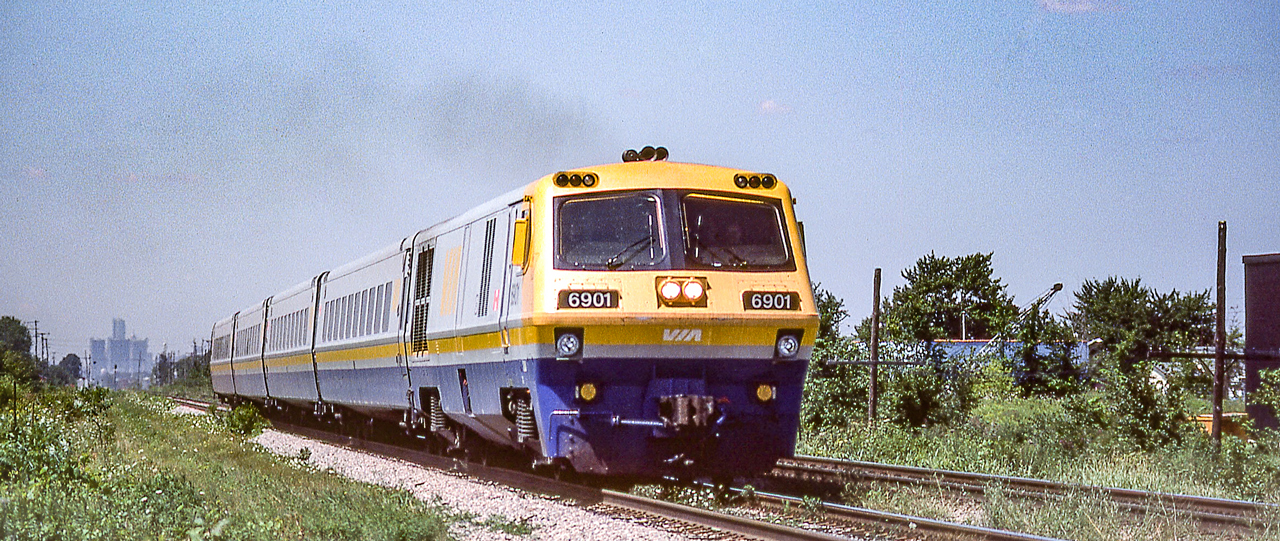 VIA 6901 is eastbound in St. Clair Beach, Ontario on August 12, 1982.
