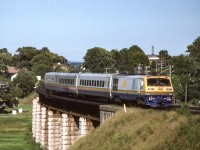 VIA 6921 is crossing the bridge in Port Hope, Ontario on August 6, 1987.