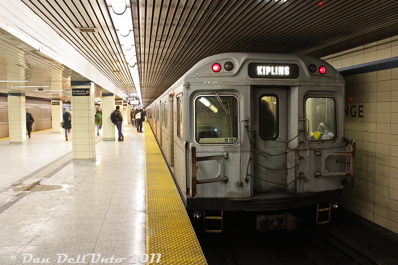 One of the fringe benefits of commuting downtown from Vaughan that made it somewhat tolerable was being able to shoot subways all the way down, or just staying onboard until our stop at Dundas (Ryerson) or Union. The old 1970's Hawker Siddeley H4's (with their orange and grey bench seats, and large roof ventilator fans) were becoming somewhat of an endangered species as the new TR subway cars began to show up, so photos of those were always in order while the getting was still good. Dirty TTC H4 5650 trails an eastbound consist at Yonge Subway Station on the crosstown Bloor-Danforth subway line ("Line 2" today) for Kennedy, as a westbound H4 consist with 5660 leading accelerates out of the station on the opposite track for Kipling.

The final H4's retired in January 2012.  Most ended up processed into scrap metal at Future Enterprises in Hamilton.