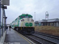 Another one from the "stations that aren't there anymore" files: Shooting an F59PH passing by the Bramalea GO station was trickier than one thought, as the CN RTC typically lined GO trains onto the south track for the easy transition to/from the Weston Sub at Halwest, thus north track shots like this (without the elevator building in the way) weren't easy to come by. Here, Georgetown line train #207 (the 4:45pm from Toronto making all stops, our ride home) powered by GO Transit F59PH 538 departs in the rain, past the station building as umbrella-toting commuters head for the stairwells and elevators.
<br><br>
The old Bramalea station, a unique and interesting low-profile mid-70's building original to the opening of the line in 1974, would be demolished in 2021 and replaced with a new Metrolinx-style GO station, bus terminal, and very large parking garage. There was some interesting wooden truss work under that roof, which always seemed to be missing a few of those light green shingles (chic for the era, no doubt). A bit of a shame there was never a station-side platform for easier access.