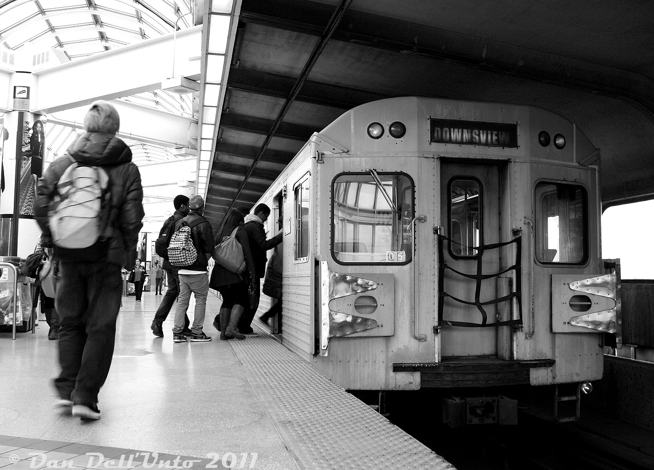 All aboard before the doors close: Passengers at Yorkdale Subway Station rush to board TTC H5 5736, trailing a Yonge-University-Spadina line train, before the chimes sound and doors slam shut for the trip southbound into Toronto.

The mid-70's Hawker Siddeley H5 fleet (yellow doors, musty air conditioner smell inside, whiny chopper control sounds) was mostly all intact at the time, but was scheduled for full replacement by the new TR trains on the YUS (Line 1). A number were resold to EKO Rail in Lagos (Nigeria) and trucked down to Buffalo NY for refurbishment, until Lagos decided to buy new rolling stock instead and all the stateside H5's were cut up for scrap. Cars not resold were sent to Hamilton for scrap, with the final H5's retired in October 2013. 

If I remember correctly, the high contrast black and white shooting style in Francis Ford Coppola's "Rumble Fish" provided some inspiration for some of my B&W subway photography at the time. It fit well for certain scenes and lighting situations.