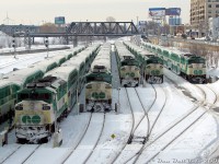It's a little bit cold in downtown Toronto this afternoon as a group of GO Transit F59PH units and their consists sit laying over in Bathurst North Yard, awaiting the call to duty for evening rush hour later in the day. From left to right are GO 524, 564, 548, 536, and 529, some idling and others plugged into the wayside electrical cabinets to keep the trains warm. All units except 564 would be dispersed to other owners a few years later, replaced by new MP40 units. 