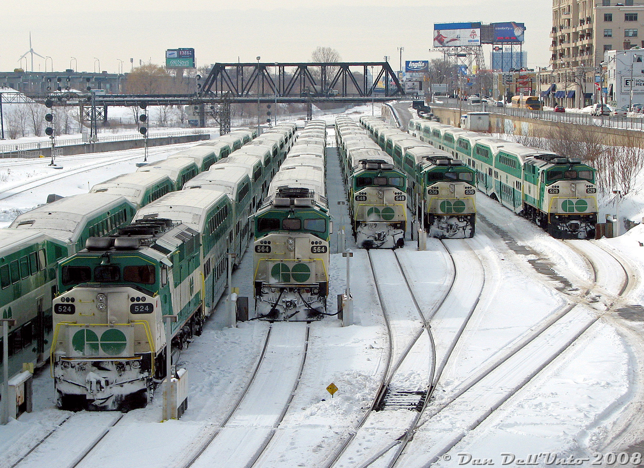 It's a little bit cold in downtown Toronto this afternoon as a group of GO Transit F59PH units and their consists sit laying over in Bathurst North Yard, awaiting the call to duty for evening rush hour later in the day. From left to right are GO 524, 564, 548, 536, and 529, all plugged into the wayside electrical cabinets to keep the trains warm. All units except 564 would be dispersed to other owners a few years later, replaced by new MP40 units.