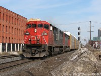A pair of back-to-back "Draper Taper" cowl units, CN C40-8M 2440 and SD50F 5434, lead afternoon train #393 westbound through downtown Brampton. They've just past the VIA/GO Brampton Station and Mill Street crossing, and are about to slam the CN-OBRY Brampton diamond just out of frame next to the photographer. Some absolutely filthy snow, piled here by the snowplow contractor in charge of clearing the south GO parking lot, sticks around as a blight on the landscape a bit longer. I recall this may have been a trip downtown with some family members, after a visit to the local coin laundry (demolished) and a lunch of Gusto's Pizza's finest (the best slice downtown, once Church & Main but since moved). Fun times.