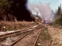 On Vancouver Island at Deerholme, CN 991 was left idling overnight when it was cold, causing excessive build-up in the exhaust system.  To minimize smoke exposure to the caboose crew on the next day’s work, at first move was a short run loading against full engine brakes, as seen here at the west end of the yard on Wednesday 1976–03-31.