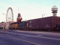 It appears strangely quiet on touristy Clifton Hill this particular evening.  No idea why. Maybe they heard the power coming? :o)  B&O 4128, C&O 3562 are heading eastbound to the USA with a long train. The track in the foreground was the spur to the Nabisco Shredded Wheat facility.  And it looks like it has not been used in some time.
Certainly has been a LOT of changes since I shot this; notably the tracks removed 20 years later.........