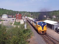 A beautiful June morning sees the southbound Northlander with ONR 2001 pulling away from a stop at the Swastika 'station' in this wide-angle view that shows most of the communities downtown area. Second unit is auxiliary power unit #205.
I'm standing on a makeshift platform of boards against a pine tree in order to get some elevation.
It will be nice to see the rebirth of the ONR Northlander. I just wish it would be a daylight run.