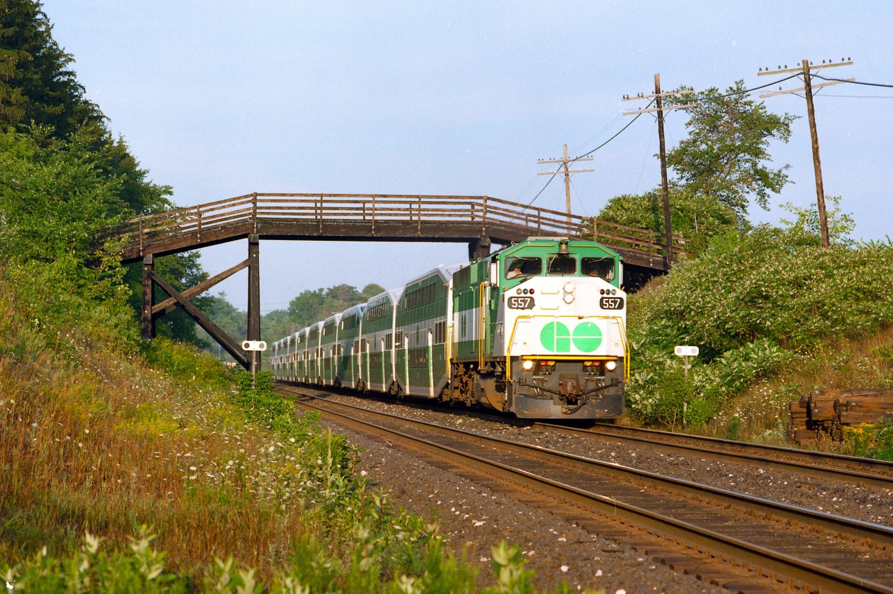 Back when the layover yard for Milton GO was at Campbellville, we see a morning train moving eastward under the farmers field access bridge by Canyon Rd.  This bridge made a nice prop for many a photo. Layover yard was moved to Milton in 2006.