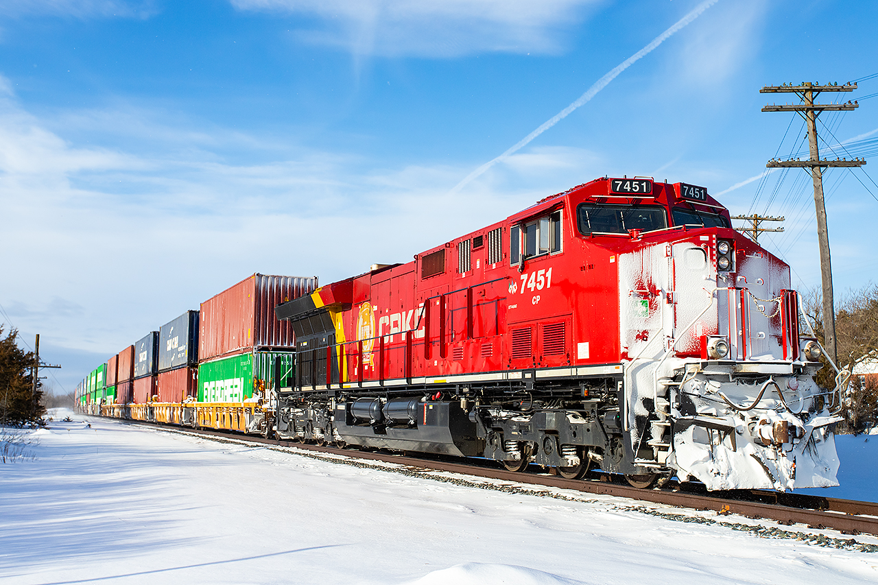 CP 7451 brings up the rear of CPKC 113 on a snowy trip down the Belleville Subdivision.