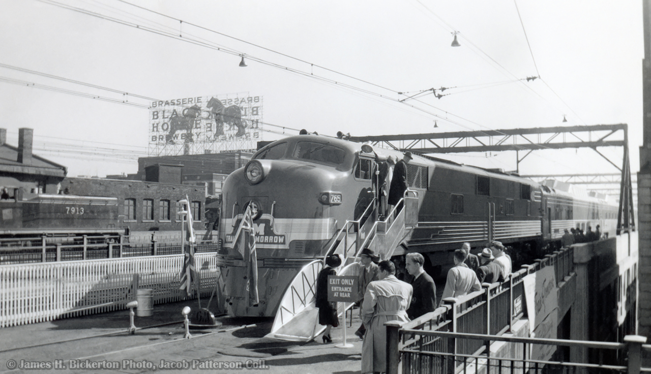 Posed for display in Montreal from September 30 – October 4, 1949, the General Motors “Train of Tomorrow.”   Consisting of E7A, GM 765, and 4 dome cars built by Pullman-Standard, the train toured the USA and Canada from 1947 – 1949, showcasing a new concept of rail travel with the new domes.  Post tour, the equipment was later sold to the Union Pacific.  At left, CNR 7913, and EMD NW2 built in 1941, can be seen moving about

During the tour, lasting from May 1947 – October 1949, the train is noted as being in Canada on three occasions.  On display at the CNE in Toronto from September 2-6, 1947, with a stop in St. Catharine’s on September 7, passing through on the CASO, from Windsor – Fort Erie on January 17, 1948, and a longer tour through Ontario and Quebec from September 22 – October 28, 1949.  Stops included London, Ottawa, Montreal, Quebec City, Sherbrooke, Oshawa, Toronto, Hamilton, St. Catharines, Stratford, Chatham, and Windsor.

James H. Bickerton Photo, Jacob Patterson Collection.