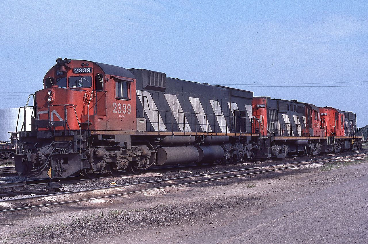 When MLW units still played a significant role in the movement of freight on CN, a trio of them are shown on the inbound receiving track at MacMillan Yard on August 7th, 1983.  The 2339 was the last of 3600 hp M636 units built for CN.  It equals the horsepower of the trailing two RS-18 units, 3734 and 3118.  I sure miss the variety we enjoyed back then.