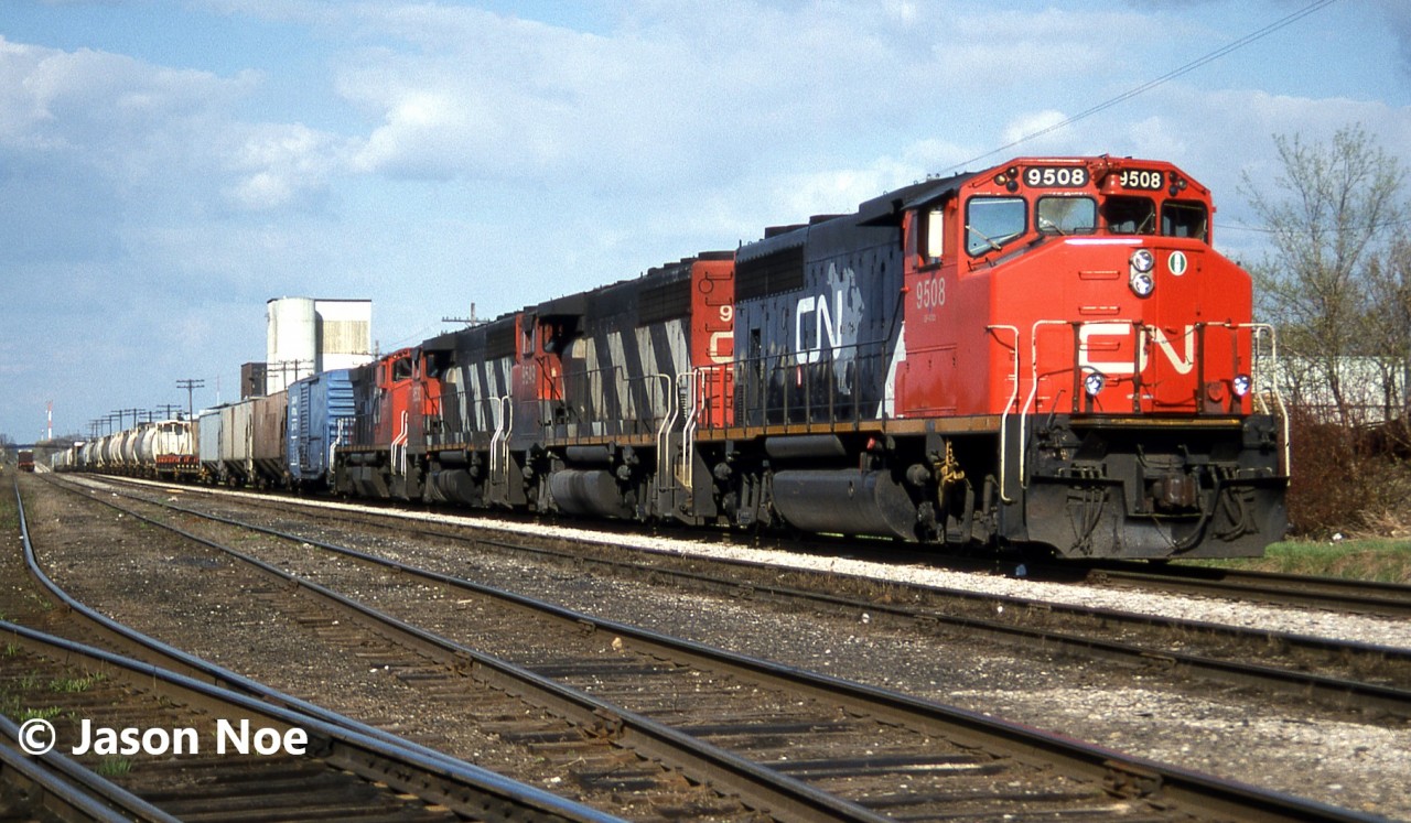 CN train 431 is viewed arriving at Kitchener, Ontario on the Guelph Subdivision with GP40-2L(W)’s 9508, 9549, 9530 and M-420(W) 3561. The crew will set-off the first six cars of their train and then lift the loaded automotive frame cars from the Budd plant before continuing west to London.