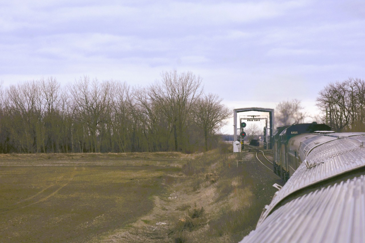 I'm about to get scanned  
VIA 693 has a clear signal and is about to leave the double track section on CN's Rivers Sub. at Mile 50.3S and pass through one of CN's numerous 'Portals' where it will be scanned with hi-def cameras and other sophisticated equipment to ensure there are no defects or concerns in the consist. 
The hi-intensity lighting inside the portal becomes quite evident when viewed from the dome of the Skyline car. 
 https://www.cn.ca/en/stories/20190814-machine-vision/