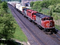 CN intermodal train 144 with GP40-2(W) 9647, SD40-2 5391 and GP40-2L(W) 9458 are passing the Georgetown, Ontario station as they head eastbound on the Halton Subdivision. CN 5391 is ex-CP 5782, which was part of a group of units originally owned by Ontario Hydro.
