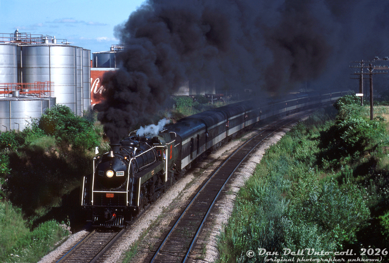 It was a nice, sunny Summer day in Niagara Falls, except for a very dark cloud in the immediate area around Portage Parkway...

Canadian National "Bullet-Nose Beatty" 4-8-2 6060 puts on an impressive smoke show leaving Niagara Falls, on one of those Spring-Summer fantrips run from Toronto to Niagara Falls and back. Passengers leaning out of the vestibule doors and baggage car are no doubt getting the full sight, sound, and smell experience of live steam today.

Original photographer unknown, Dan Dell'Unto collection slide.