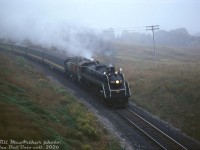 Steam on a gloomy day is still steam. Heading northbound on the Newmarket Sub on a fantrip to the Orillia/Barrie area, Canadian National 4-8-2 6060 takes the curve at King City, about to duck under the underpasses at King Road and Keele Street.<br><br>Compare this to <a href=http://www.railpictures.ca/?attachment_id=56537><b>John Freyseng's earlier RDC image</b></a> when this location was still a grade crossing (grade-separated sometime in the 1970's).<br><br><i>Bill McArthur photo, Dan Dell'Unto collection slide.</i>