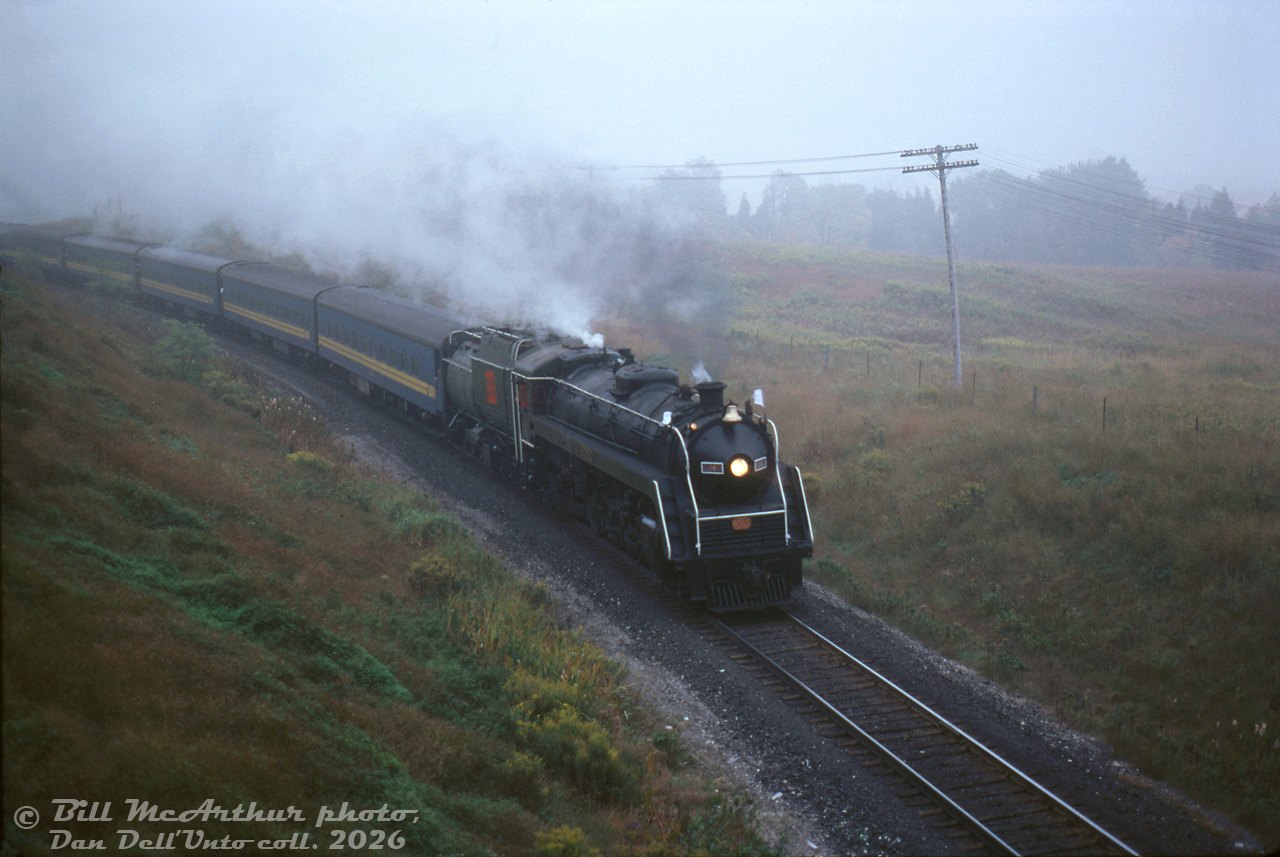 Steam on a gloomy day is still steam. Heading northbound on the Newmarket Sub on a fantrip to the Orillia/Barrie area, Canadian National 4-8-2 6060 takes the curve at King City, about to duck under the underpasses at King Road and Keele Street.

Compare this to John Freyseng's earlier RDC image when this location was still a grade crossing (grade-separated sometime in the 1970's).

Bill McArthur photo, Dan Dell'Unto collection slide.
