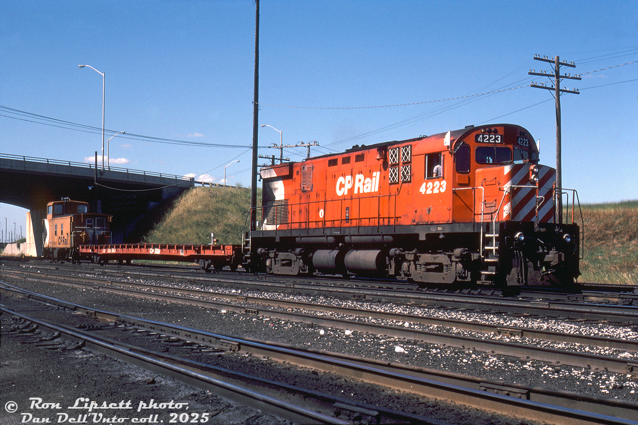 By the mid-80's, the Lindsay Turn wasn't looking so hot - a reflection of the decreasing traffic on many of the southern Ontario branchlines that were struggling to stay alive or being abandoned at the time. CP Rail C424 4223 sits at the northeast corner of CP's Toronto (Agincourt) Yard by the Finch Avenue East overpass, ready to head out onto the Havelock Sub with its short train in tow: a single empty flatcar, and a 434000-series offset-cupola steel caboose. Once on the Havelock, it would hop on the Bobcaygeon Sub at Dranoel for its ultimate destination of Lindsay, Ontario. Rail service to and in Lindsay, once a bustling hub of branchlines itself, would end in two more years when the Bobcaygeon Sub was abandoned in November 1987, and that would be it for CP's Lindsay Turn. The 4200-series C424 fleet, modified in the early 80's from DRF to DRS-24 roadswitcher units for branchline service, would continue to operate into the late 90's before the final units were retired.

Ron Lipsett photo, Dan Dell'Unto collection slide.