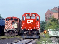 Canadian Pacific GP40-2 4657 (one of a handful of former B&M units acquired secondhand from Helm Leasing) sits in CP's Kinnear Yard next to SD40-2F 9004, as maintenance employees appear to be working on the power. Note what appears to be environmental anti-spill mats placed along the closest track.<br><br><i>Bill McArthur photo, Dan Dell'Unto collection slide.</i>