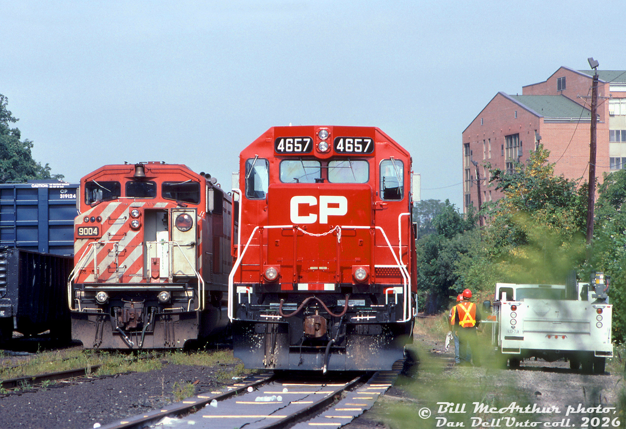 Canadian Pacific GP40-2 4657 (one of a handful or former B&M units acquired secondhand from Helm Leasing) sits in CP's Kinnear Yard next to SD40-2F 9004, as maintenance employees appear to be working on the power. Note what appears to be environmental anti-spill mats placed along the closest track.

Bill McArthur photo, Dan Dell'Unto collection slide.