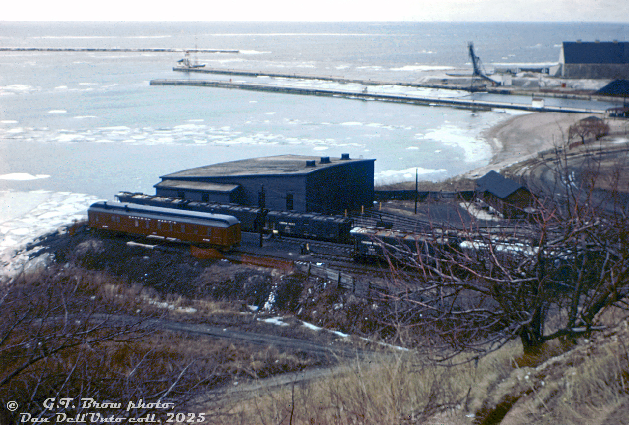 This hillside view shows Canadian Pacific's roundhouse and turntable at their yard in Goderich, Ontario. An abundance of "slab-side" covered hoppers and an old passenger car converted into an OCS work car are present. At this time, some of the harbour and salt facility in the background had not yet been expanded out.

The turntable survived into the 1980's but the roundhouse appears to have been demolished just after the end of the steam era (gone in this Bill Thomson photo). CP abandoned their Owen Sound Sub between Orangeville and Owen Sound in December 1995.

G.T. Brow photo, Dan Dell'Unto collection. This old slide had badly colour shifted and washed out, it took some coaxing to get it cleaned up and presentable.