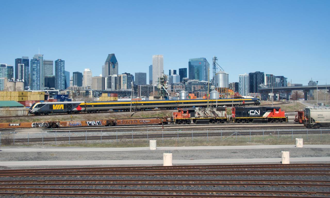 VIA 24 has just left Central Station and is temporarily running west so that it can wye before heading east toward Quebec City (presumably there is some issue with the locomotive on this consist which makes it trail only). In the foreground, CN 500 is backing up before heading to the Port of Montreal.