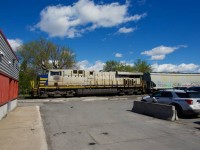 CN 305 is passing Coteau Station with an ex-CREX unit as the sole head end unit.
