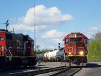 GTW power (repainted and not) meets at Coteau as GTW 5820 backs up past parked GTW 6226 as the former leads CN 538 at Coteau.