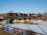 CN 543 is returning from  the Port of Montreal with CN 7060, CN 7017, CN 4712 & IC 9639 for power as it crosses the Lachine canal. The GP9s had picked up CN 500's dead power off of the nearby East Side Canal Bank Spur a bit earlier that afternoon.