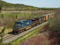 BC Rail Dash 9-44CW #4653 leads train 403 at the Route 132 overpass in Bic on a wonderful but cold Patriots Day. BCOL 4653 is the first BC Rail locomotive this year to roam the Mont-Joli subdivision, they are far less common since the Dash 8 locomotives were retired... Trailing mid-consist was a set of about a dozen former BC Rail woodchip gondolas recently acquired by the Gaspésie Railway. They were the first loads of woodchips to come through in about a year, although they weren't headed for Rivière-du-Loup this time... I am not sure who is the new customer that recieves these loads. New traffic sure is welcome!