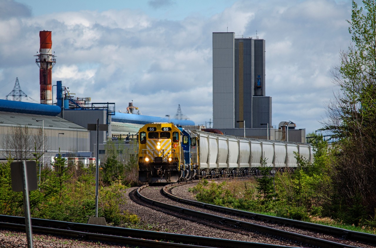 Locomotives 65, PRLX 2270 and 63 switches the alumina hopper cars at the Laterrière aluminium smelter. The Roberval & Saguenay railway services this plant along with the Grande Baie one up to 3 times a day.