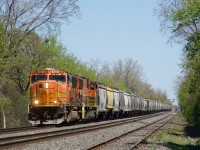 An empty Quebec Gatineau grain train is about to enter CPKC's St-Luc Yard with SD70MACs QGRY 4021 & QGRY 4018.