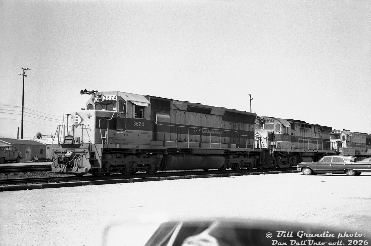 Not your typical Bill Grandin "drive-by" yard shot: the power for Erie Lackawanna train NE97 sits inside CP's Toronto (Agincourt) Yard, one of many trains detouring through Canada over CN and CP due to Hurricane Agnes damaging EL's rail network in the US. Pictured are EL SD45 3624, C424 2413, U25B 2505 and 2501 (not shown), laying over before continuing their trip west over CP and back into the states.

No Canadian railways ever opted for EMD's big 3600hp V20-powered SD45 model, most preferring the 3000hp SD40/SD40-2 as their normal high horsepower 6-axle unit of choice. EL rostered a sizable fleet of SD45 and SDP45 units, that later joined PRR's fleet in the 1976 Conrail merger.

Bill Grandin photo, Dan Dell'Unto collection negative.