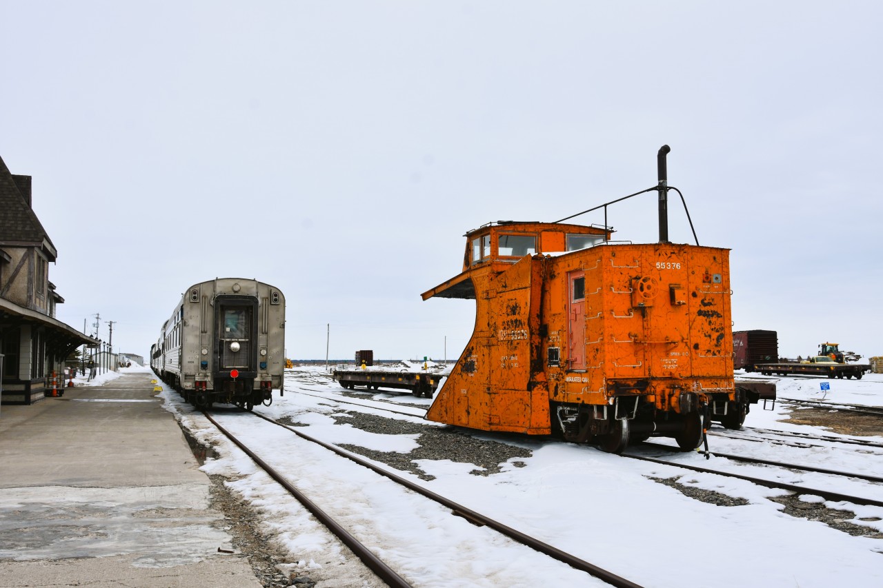 167 and counting  
VIA 693 is backed in on track ZC41 the station track at Churchill, MB while HBRY 55376 (ex-CN 55376) single track snowplow rests on the mainline at End of Subdivision in Churchill Yard. 
The trailing passenger car in VIA 693's consist is VIA 8224 Chateau Roberval sleeper built in November of 1954 making it 71 years old. 
HBRY 55376 (ex-CN 55376) was built in March 1930 making it 96 years old! 
As witnessed on my recent trip to Churchill, both are still functioning as intended when built new, with a total accumulated years of service of 167+. 
Both are clearly showing their age, the Chateau sleeper on the inside, and the snowplow on the outside. 
I hope to catch them both several more times on future trips. 
At the rate they are going, it would appear both pieces of equipment will outlast me!
