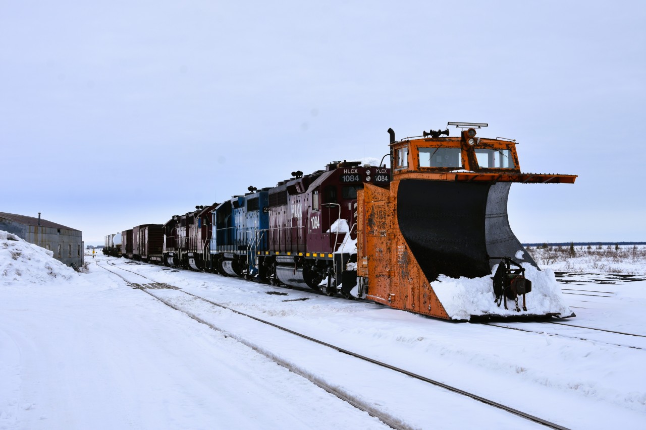 Surprise, Surprise  
After arriving in Churchill and having a hearty breakfast at The Seaport Hotel I started my day of photography back at the station platform capturing the consist of VIA 693 and several pieces of equipment in the yard while awaiting the arrival of the HBR way freight. 
A headlight finally came into view at the south end of the yard, but it was not the standard triangle of headlight and ditch lights I was expecting. 
As the movement got closer, and much to my surprise, I could see the lead equipment on the way freight was HBRY 55376 (ex-CN 55376) mainline snowplow. 
The deceiving headlight turned out to be a standard locomotive headlight with only one functioning bulb, and an L.E.D. light bar. 
While the overcast skies were not the best light conditions, I think the subject matter more than made up for it.  
The two-man crew of the way freight was very cooperative in my picture taking efforts that morning. 
What a great way to start the day in Churchill!