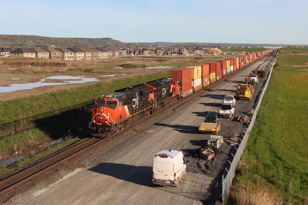 Q139 CN 3061 CN 3170 at Britannia Road. The trucks are starting to show up for another days work on the new track construction.
