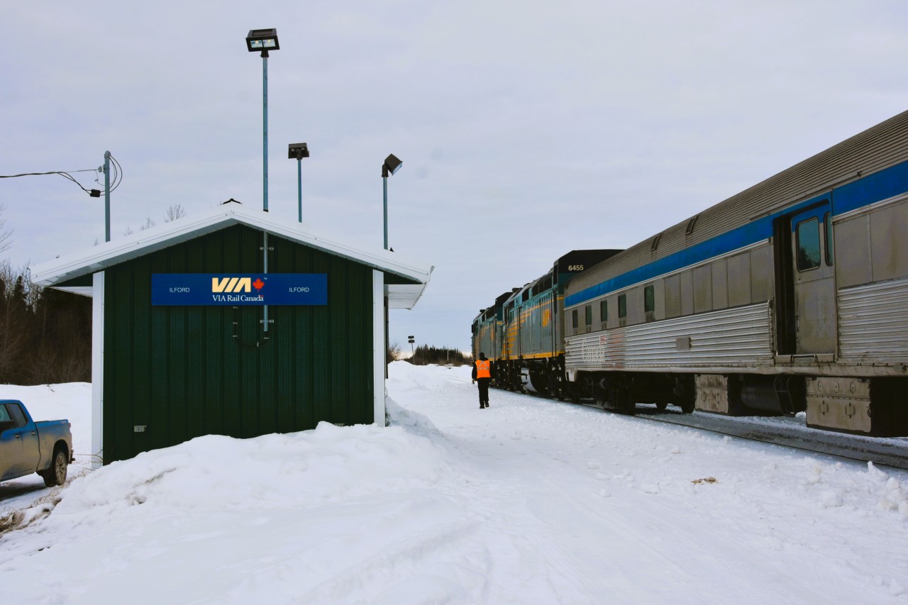 Heading back to the cab  
It's early morning in Ilford, MB where VIA 692 the southbound passenger train from Churchill has made its scheduled stop. 
Passengers are all boarded, baggage has been loaded, and as the baggage car door slides closed the second engineer makes his way back to the locomotive to continue the trek towards Winnipeg. 
Ilford is just one of the many remote locations where this VIA lifeline train stops along the 1,024 km (636 mile) route.