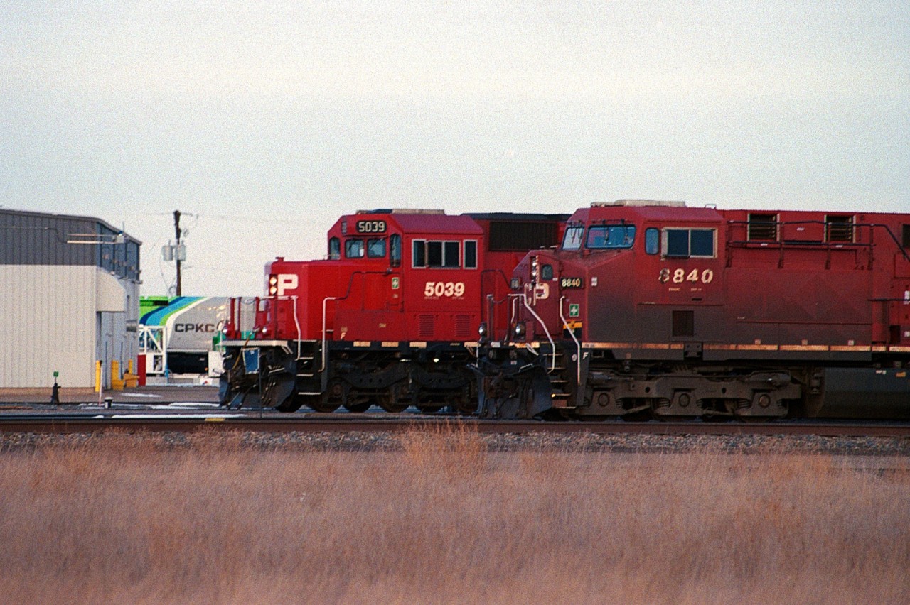 Canadian Pacific 8840 waiting for clearance to depart Kipp Yard, while Canadian Pacific 5039 and another engine switch tankers around the yard while one of the CPKC hydrogen units hide's behind the repair shop.